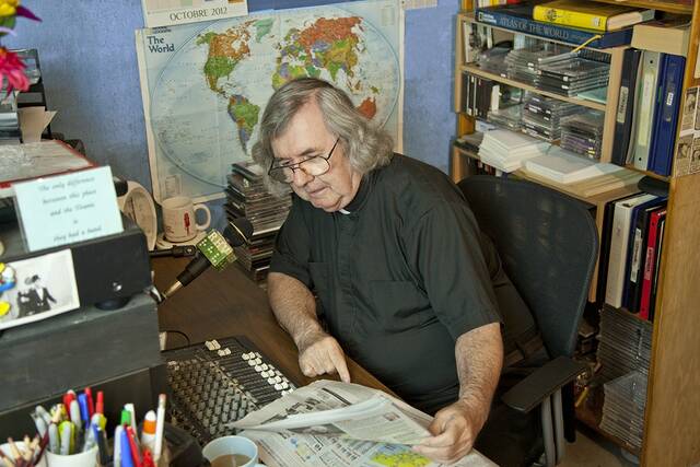 The late Rev. Thomas Carten reading the news during ‘The Radio Home Visitor’ segment.
                                 Submitted